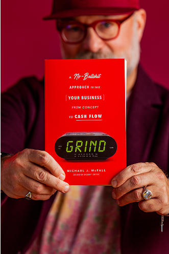 Mike holding his book Grind